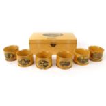 Boxed set of six wooden Mauchlin ware napkin rings decorated with Robbie Burns, the lid decorated