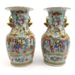 Large pair of oriental Chinese vases decorated with panels of court scenes and gilt dragon