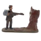 American cast iron mechanical money bank with soldier firing a gun into a tree, stamped 'Creedmoor