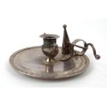 Silver coloured metal chamberstick and candle snuffer in the form of a genie's lamp, 16.5cm diameter