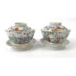 Pair of oriental Chinese famille rose porcelain bowls and covers on stands decorated with children