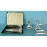 Cased set of six silver knives, pair of silver dwarf candlesticks and three silver handled knives,