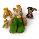 Steiff rabbit, two miniature jointed teddy bears and a black felt dog, the largest 23cm high : For