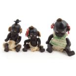Three miniature bisque black baby dolls, impressed 'Japan' on their backs, the largest 9.5cm