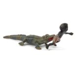 Small cold painted bronze of a crocodile biting a black boy's bottom, 6cm long : For Condition