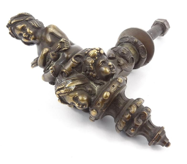 Victorian bronze handle depicting a garlanded cherub, 12cm high : For Condition Reports please visit