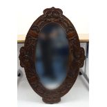 Large oak framed mirror carved with serpents, 108cm long : For Condition Reports please visit www.
