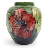 Moorcroft Hibiscus patterned pottery vase, paper label Potters to the Late Queen Mary to base,