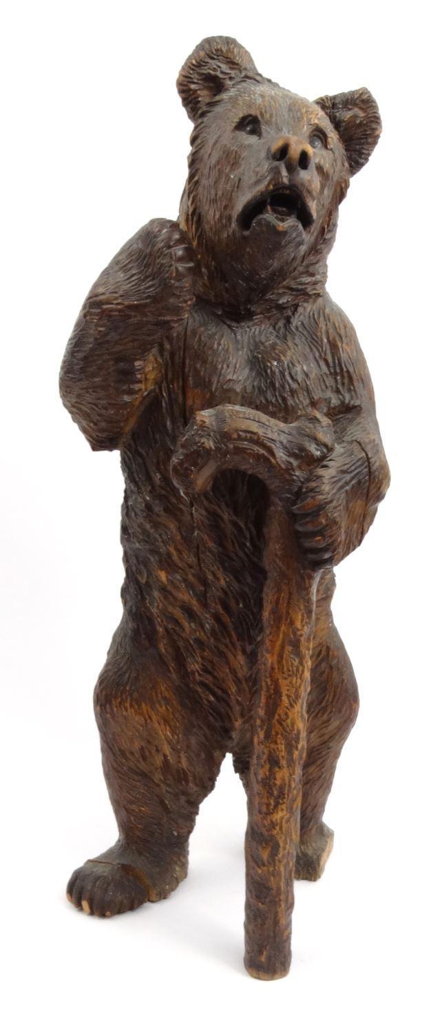 Large wooden carved Black Forest model of a bear with a walking stick, 56cm high : For Condition