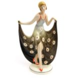 Art Deco Katzhutte pottery figure of a maiden in a flowing floral dress and wearing orange shoes,