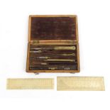 Brass drawing instrument set with two ivory rulers, housed in a mahogany box, the rulers 15cm long :