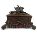 Black Forest wooden tea caddy carved with birds, grapes and vines, 36cm wide : For Condition Reports