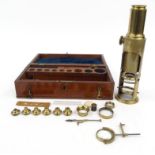 Students brass microscope with a selection of lenses and slides, housed in a fitted mahogany case,