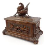 Black Forest wooden cigar box carved with birds and foliage, 38cm long : For Condition Reports