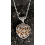 A silver heart shaped necklace set with