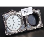 A silver hallmarked clock an picture fra