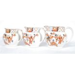 A set of 3 Imari pattern graduating jugs