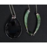 2 silver and jade tooth shaped pendants