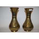 A pair of early 20th century hammered Indian brass vases having decorative animal scene designs with