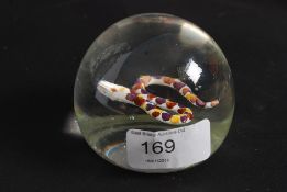 A 20th century glass paperweight in the manner of Paul Ysart having inset snake to centre