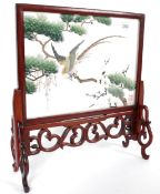 A 20th century miniature Chinese oriental hardwood and silk worked fire screen