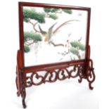 A 20th century miniature Chinese oriental hardwood and silk worked fire screen