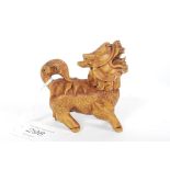 An intricate carved netsuke style temple dog / dragon with inset black eyes.