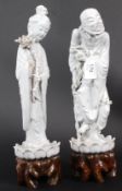 2 19th century Chinese glazed figures being raised over pierced wooden socles