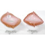 A pair of early 20th century vaseline glass vases having milk glass bodies with pink interiors