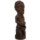 An African Naga / Assam tribal fertility statue having roped conch shell to centre being raised on a