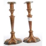 A pair of copper and brass candlesticks