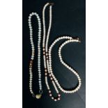 A necklace with three rows of pearls.