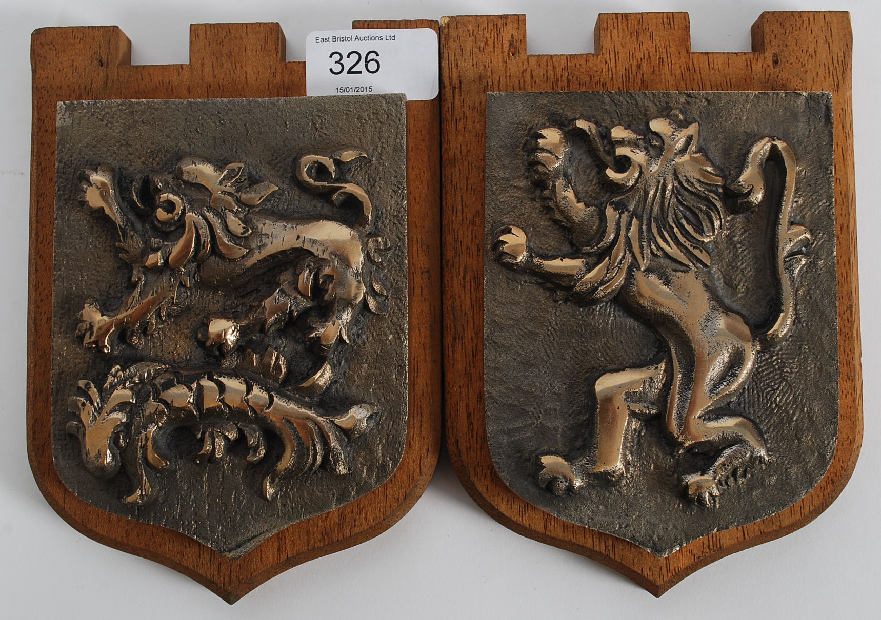 A pair of cast bronze armorial crests mo