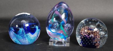 A collection of paperweights to include