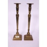 A pair of large brass candlesticks in th