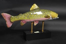 A large ceramic rainbow trout on a stand