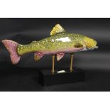 A large ceramic rainbow trout on a stand