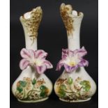 A pair of 20th century Staffordshire vases having waisted necks being embellished with flowers. 23.
