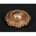 A 9ct gold Victorian hair locket brooch, the rear with glass panel having hair inside with pin.