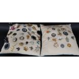 A large collection of costume jewellery brooches displayed on two pads