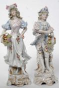 A pair of 20th century continental Meissen style ceramic figures one of a gent the other of a lady.