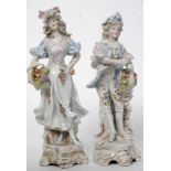 A pair of 20th century continental Meissen style ceramic figures one of a gent the other of a lady.