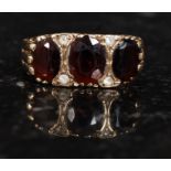 A 9ct gold and ruby garnet and believed diamond garnet ring. Measures: 4.1g size V.