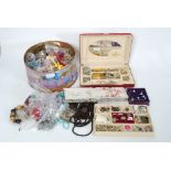 A large assortment of costume jewellery to include brooches, necklaces,