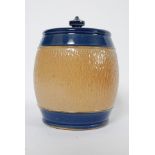 An early 20th century Royal Doulton stoneware glazed two tone biscuit barrel complete with lid