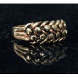 A 9ct gold Celtic style ring, with twist pattern to shoulders. Weight 4.9g size S.