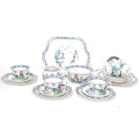 A vintage 20th century Chinese influence / willow pattern part tea service comprising cups saucers,