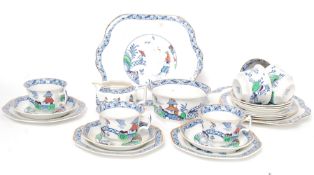 A vintage 20th century Chinese influence / willow pattern part tea service comprising cups saucers,