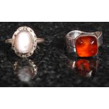 A silver 925 amber ladies dress ring together with a silver ladies cameo ring. Both stamped 925.