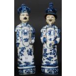 A  pair of 20th century Chinese blue and white figurines of scholars bearing character marks to the